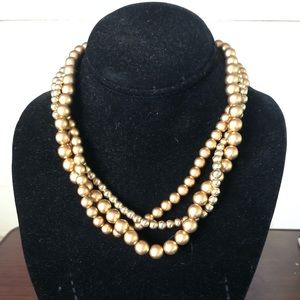 Gold colored three strand evening necklace